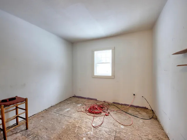 a room with furniture and white walls
