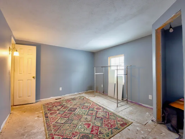 an empty room with closet and a bathroom