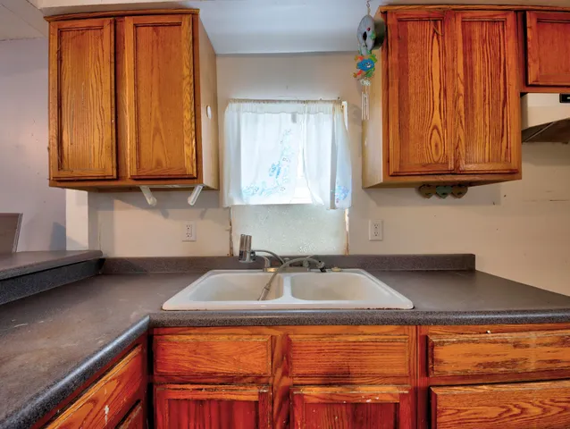 a kitchen with stainless steel appliances granite countertop wooden cabinets a sink and dishwasher