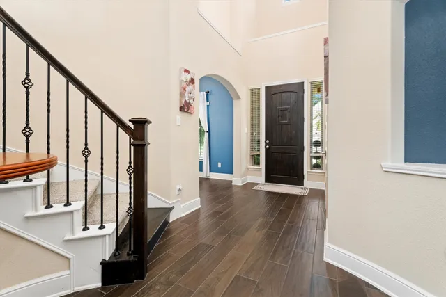 a view of an entryway with wooden floor and door