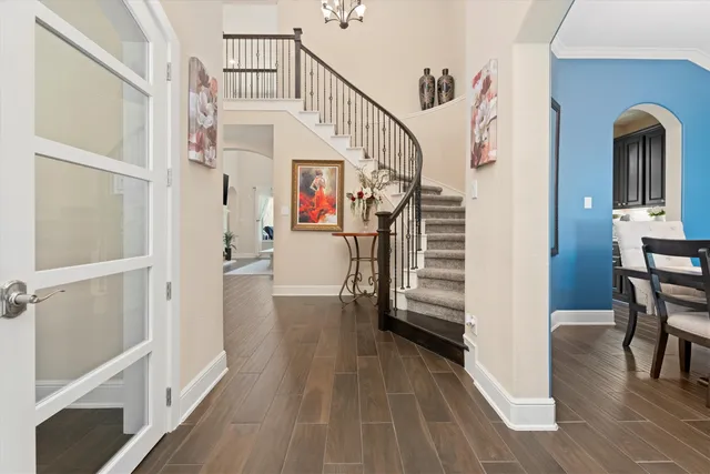 a view of entryway and hall with wooden floor