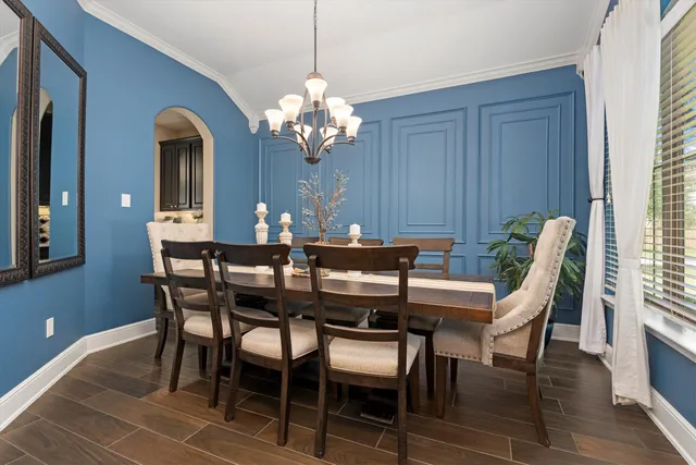 a view of a dining room with furniture wooden floor and chandelier