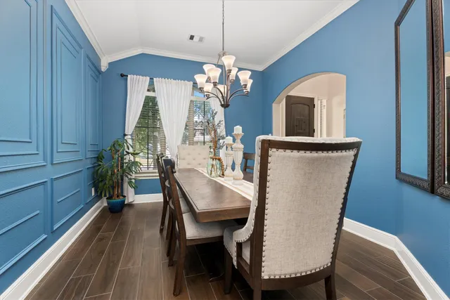 a view of a dining room with furniture and wooden floor