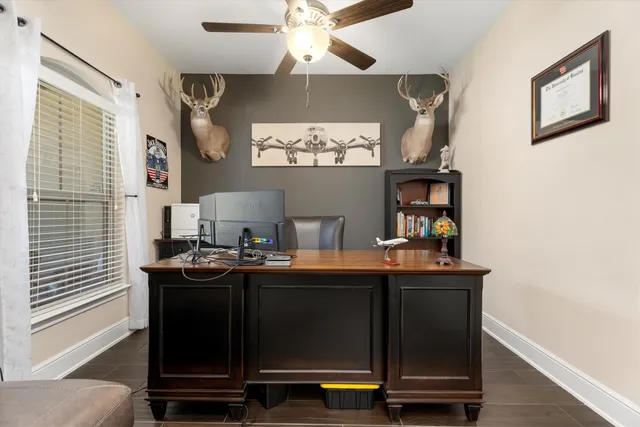 a view of a workspace with furniture and a window