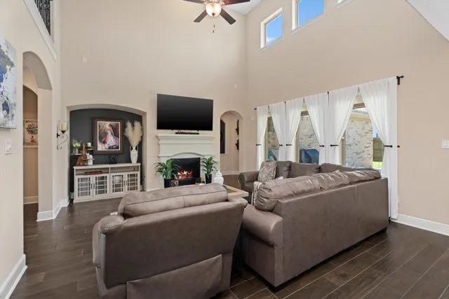 a living room with furniture a flat screen tv and a fireplace