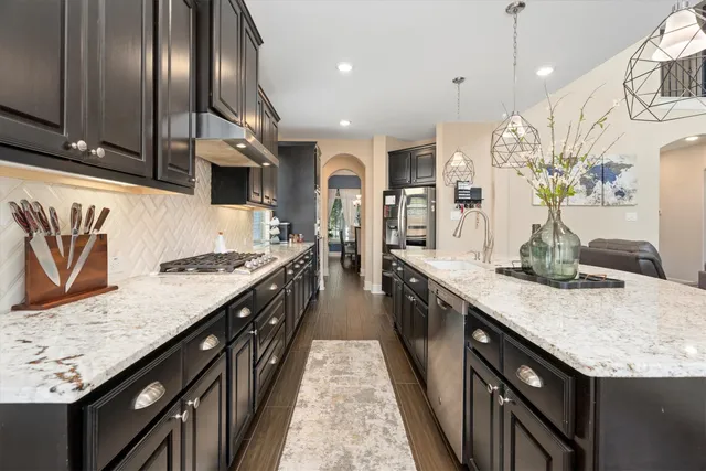 a large kitchen with stainless steel appliances granite countertop plenty wooden cabinets