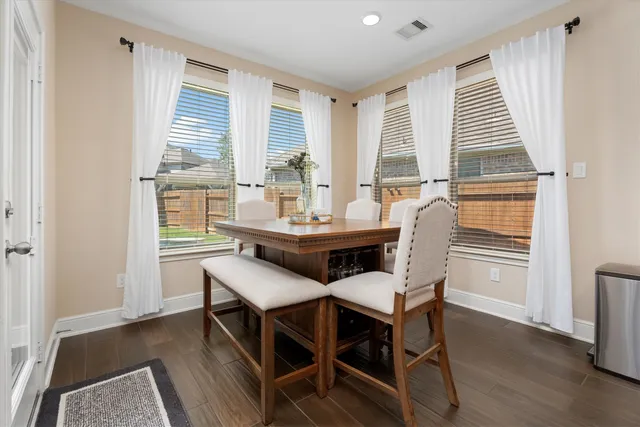 a dining room with furniture and window