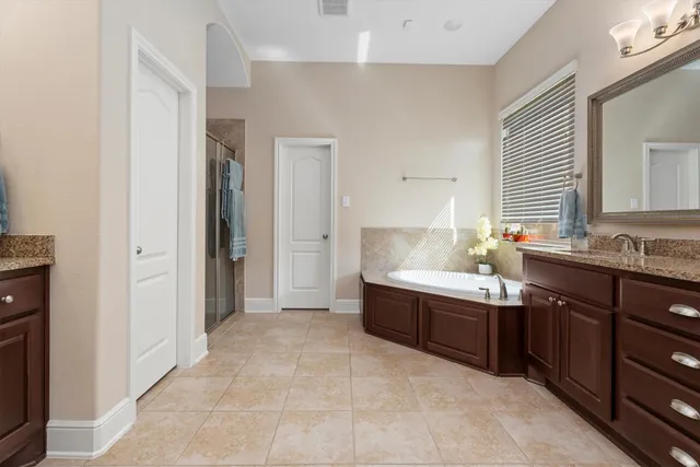 a spacious bathroom with a sink mirror and a bathtub