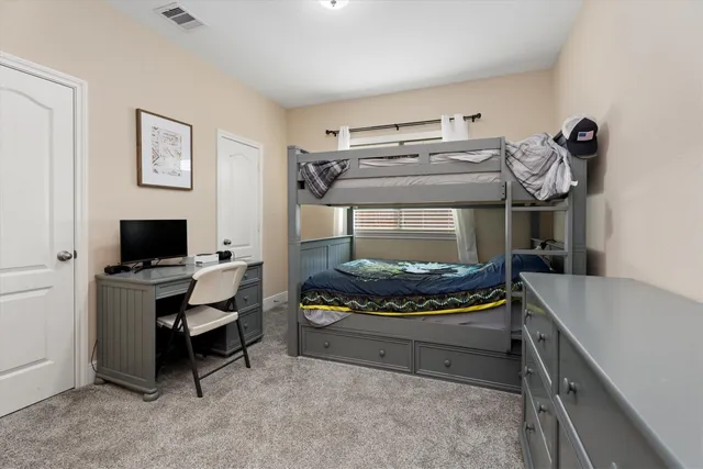 a bedroom with a bed and a desk