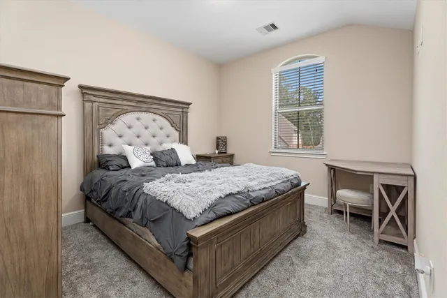 a bedroom with a bed and window