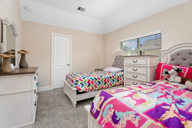 a bedroom with two beds and a dresser