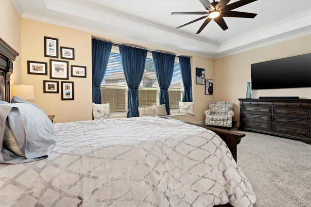 a bedroom with a large bed and a flat screen tv