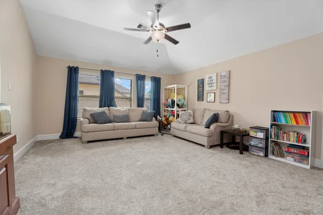a living room with furniture and a book shelf