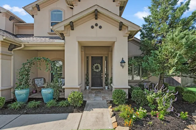 a front view of a house with garden
