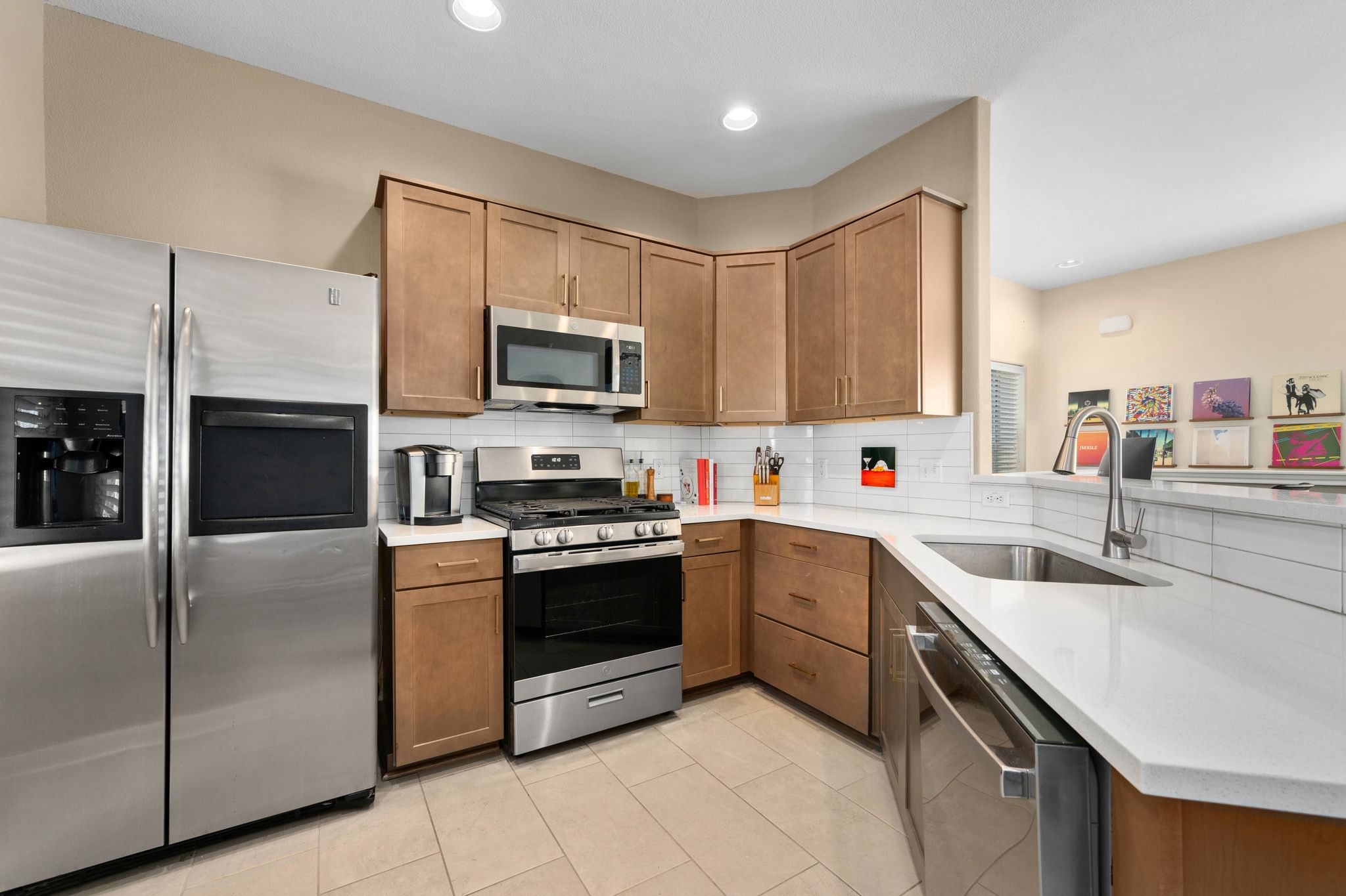 2905 Saville Loop Austin, TX 78741 - Photo 13 of 30 a kitchen with stainless steel appliances granite countertop a sink and stove top oven