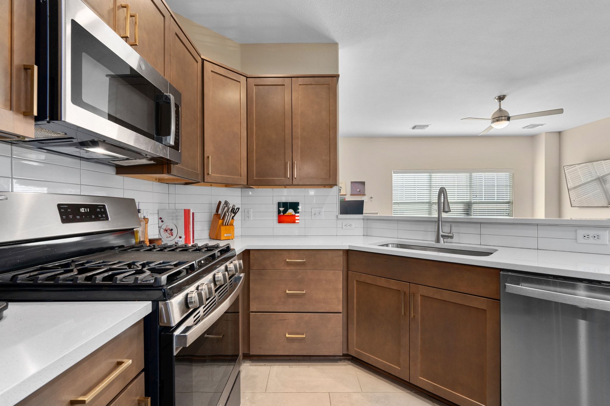 2905 Saville Loop Austin, TX 78741 - Photo 15 of 30 a kitchen with stainless steel appliances a sink stove and microwave