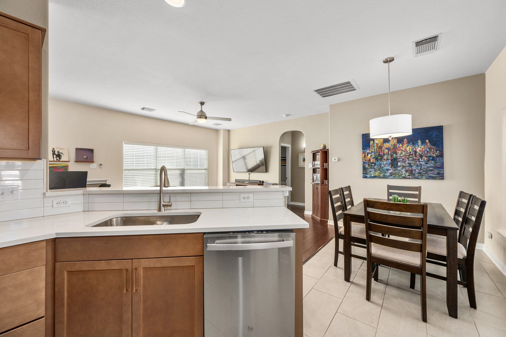 2905 Saville Loop Austin, TX 78741 - Photo 16 of 30 a kitchen with a dining table chairs and white cabinets