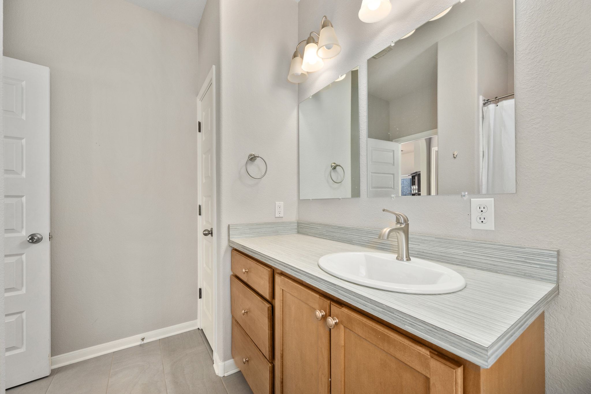 2905 Saville Loop Austin, TX 78741 - Photo 19 of 30 a bathroom with a sink and a mirror