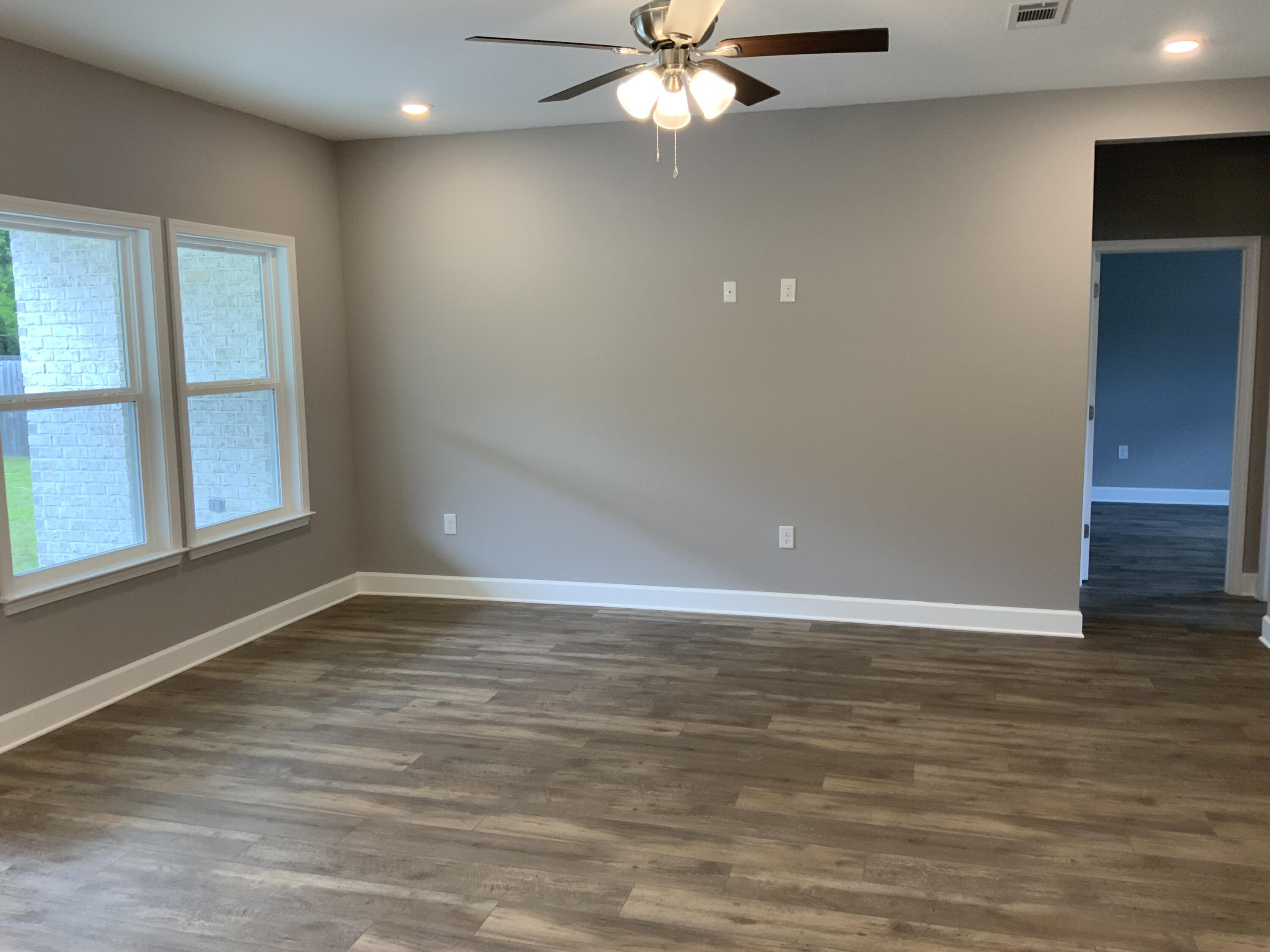 5188 Rabbit Run Crestview, FL 32539 - Photo 3 of 13 wooden floor in an empty room with a window