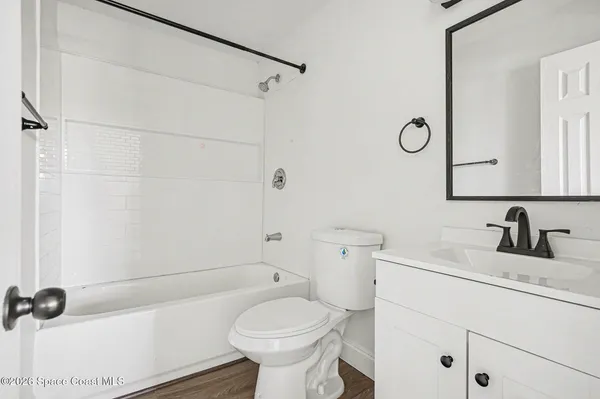 a bathroom with a sink toilet vanity and shower