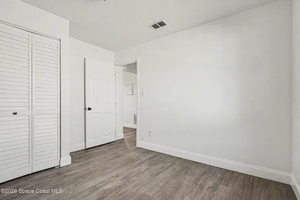 an empty room with wooden floor