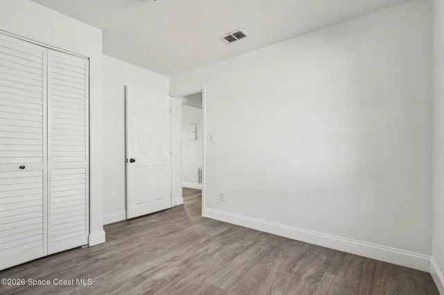 an empty room with wooden floor