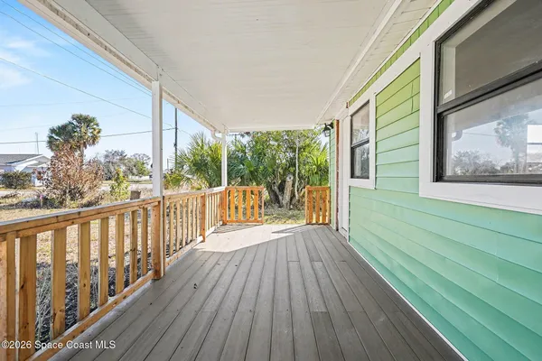 a view of a balcony with wooden floor