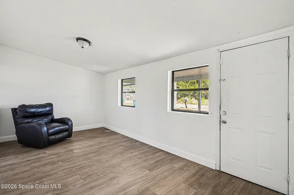 an empty room with windows and closet