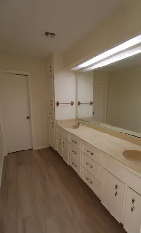 a bathroom with a double vanity sink and a mirror