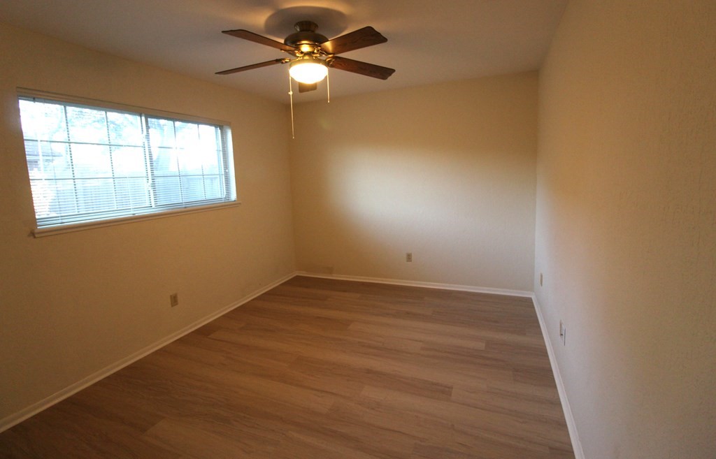 1910 Oak Ridge Drive Portland, TX 78374 - Photo 23 of 40 an empty room with a window and a fan