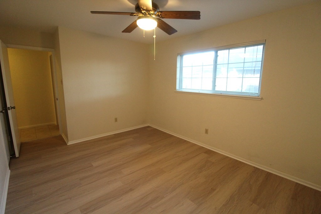 1910 Oak Ridge Drive Portland, TX 78374 - Photo 24 of 40 an empty room with wooden floor fan and windows