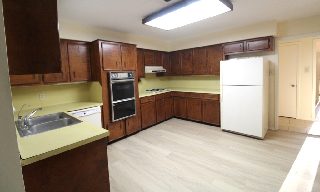 1910 Oak Ridge Drive Portland, TX 78374 - Photo 31 of 40 a kitchen with stainless steel appliances wooden cabinets and sink