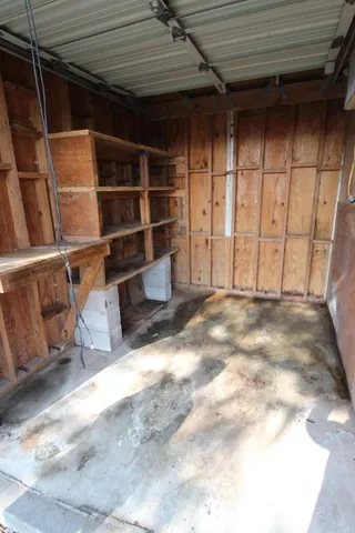 a view of walk in closet with empty racks