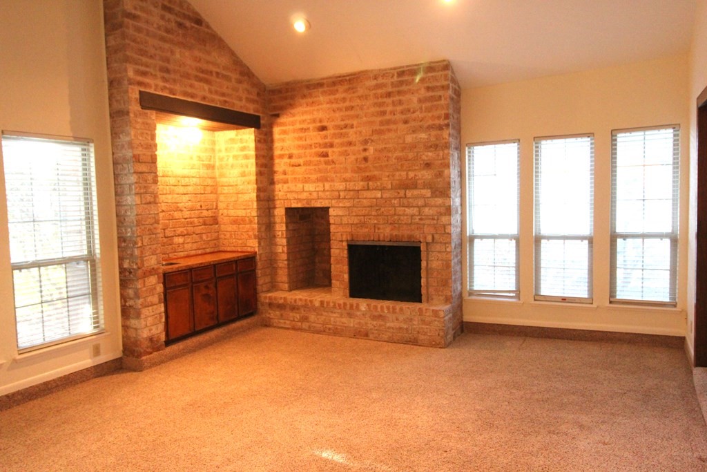 1910 Oak Ridge Drive Portland, TX 78374 - Photo 5 of 40 a view of an empty room with a fireplace and a window
