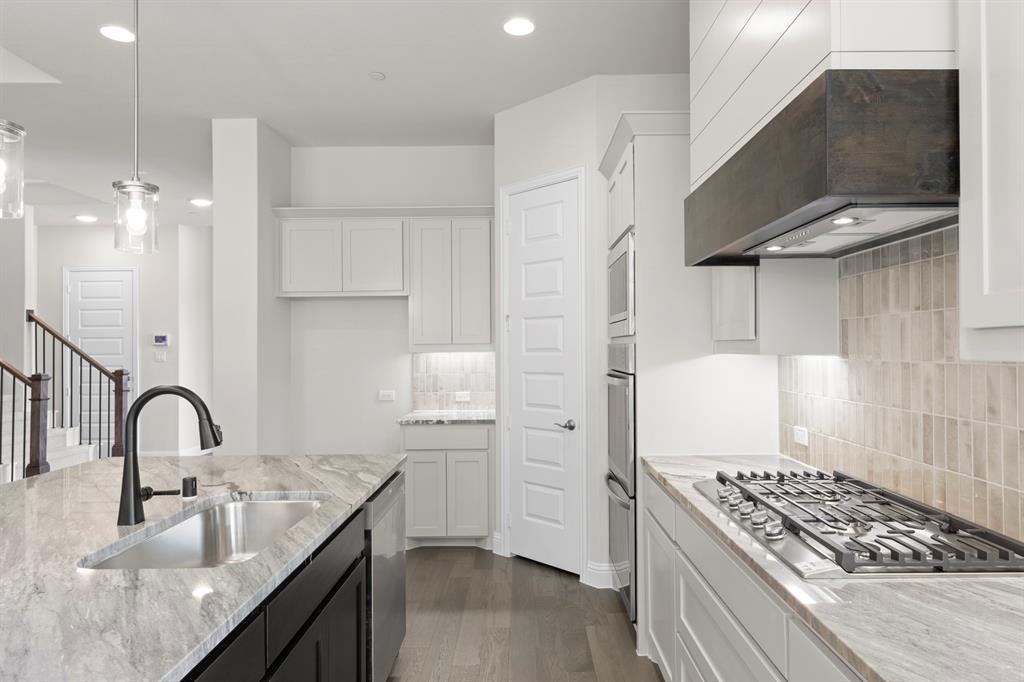 708 Splendor Drive McKinney, TX 75072 - Photo 12 of 29 a kitchen with sink stove and cabinets