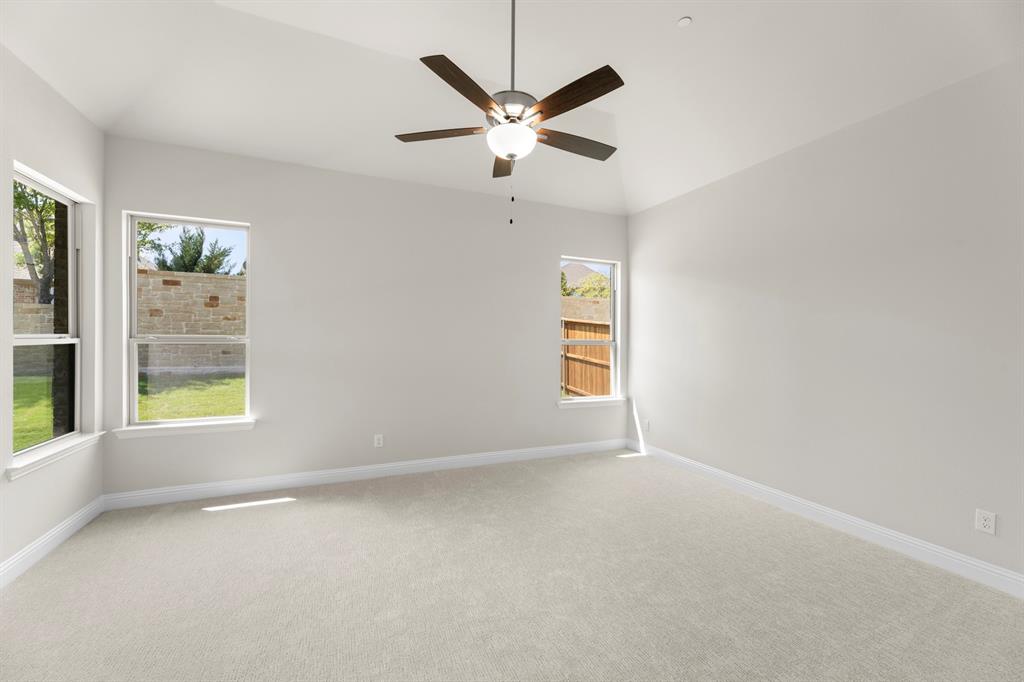 708 Splendor Drive McKinney, TX 75072 - Photo 15 of 29 an empty room with windows and ceiling fan