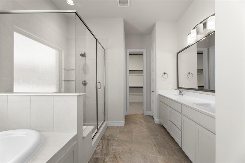 708 Splendor Drive McKinney, TX 75072 - Photo 17 of 29 a bathroom with a bathtub and a shower