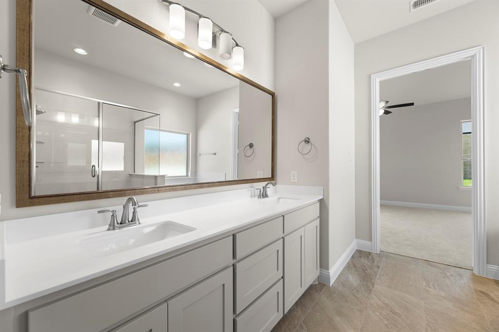 708 Splendor Drive McKinney, TX 75072 - Photo 18 of 29 a bathroom with double sink and a mirror