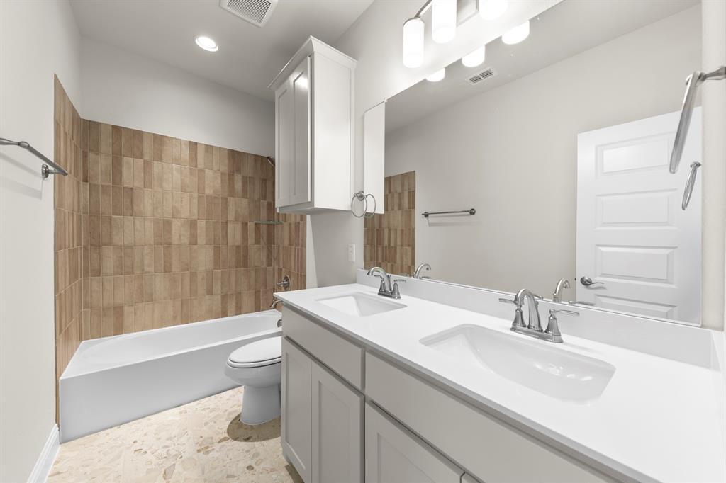 708 Splendor Drive McKinney, TX 75072 - Photo 23 of 29 a bathroom with a sink a toilet and shower