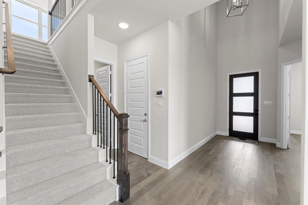 708 Splendor Drive McKinney, TX 75072 - Photo 3 of 29 a view of entryway with wooden floor and stairs