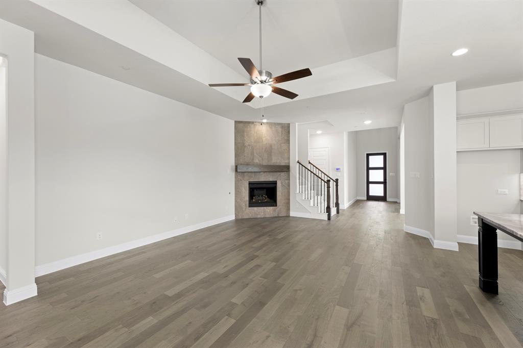708 Splendor Drive McKinney, TX 75072 - Photo 9 of 29 a view of an empty room with window and wooden floor