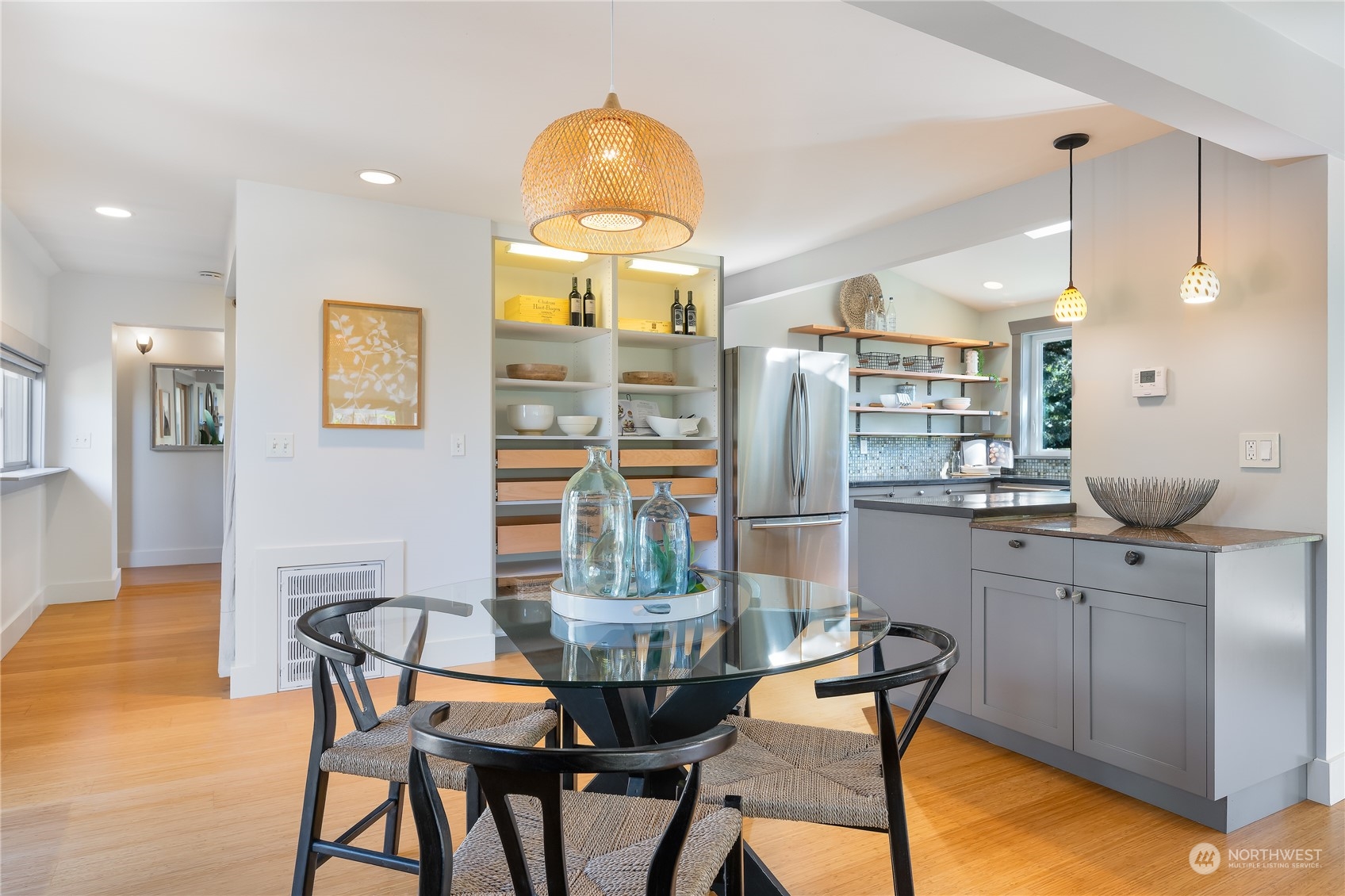 1408 Northwest 73rd Street Seattle, WA 98117 - Photo 13 of 40 a kitchen with stainless steel appliances kitchen island granite countertop a refrigerator a stove a kitchen island with chairs and wooden floor