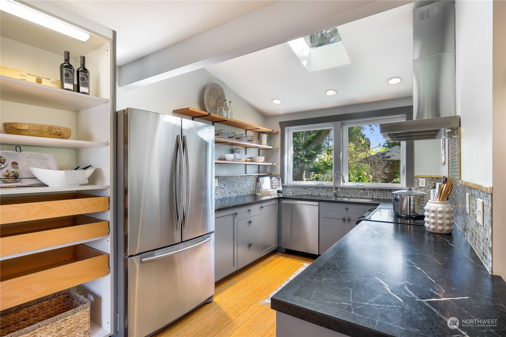 1408 Northwest 73rd Street Seattle, WA 98117 - Photo 14 of 40 a kitchen with stainless steel appliances granite countertop a refrigerator and a sink