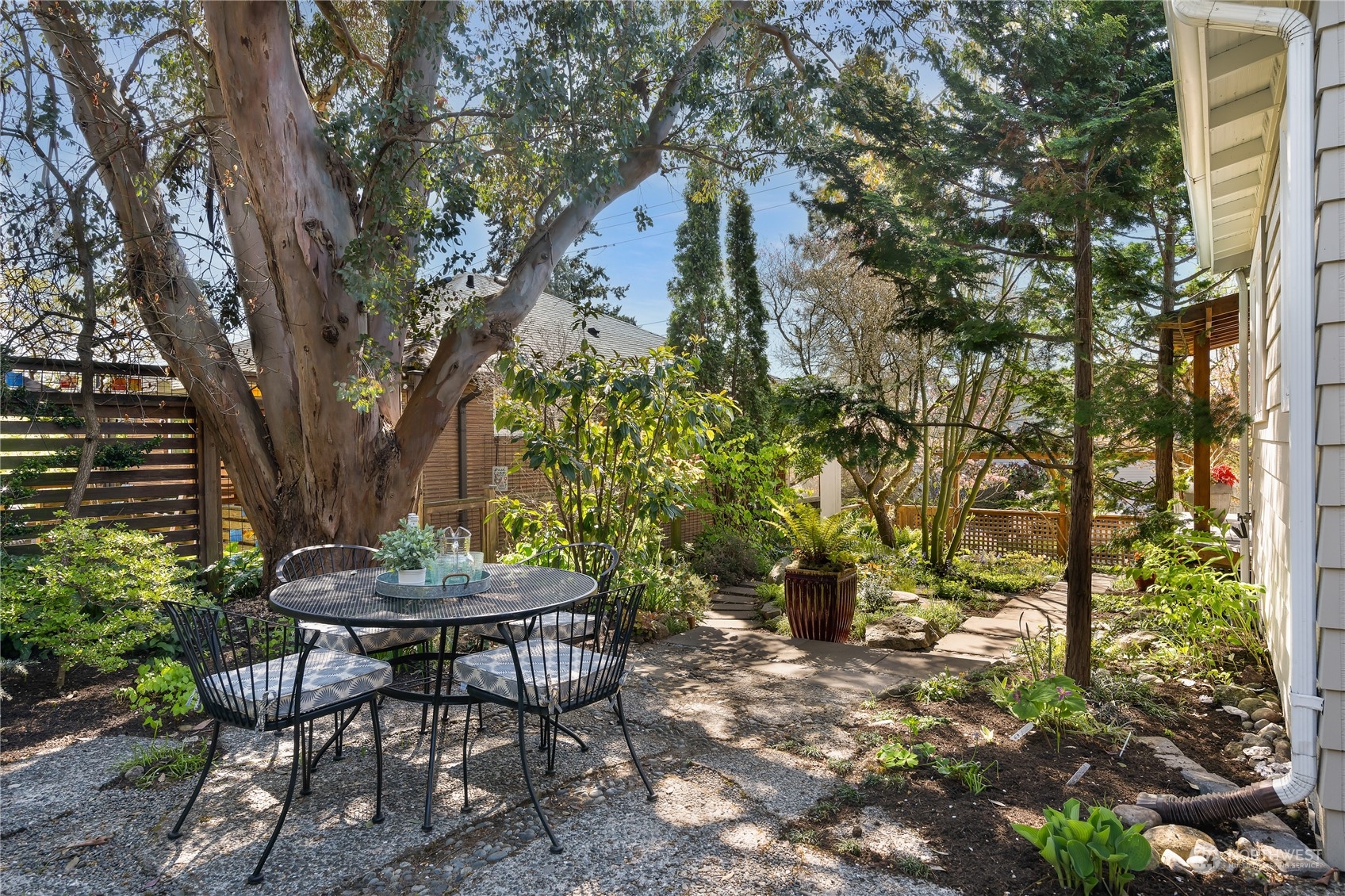 1408 Northwest 73rd Street Seattle, WA 98117 - Photo 32 of 40 a view of a backyard with table and chairs and potted plants