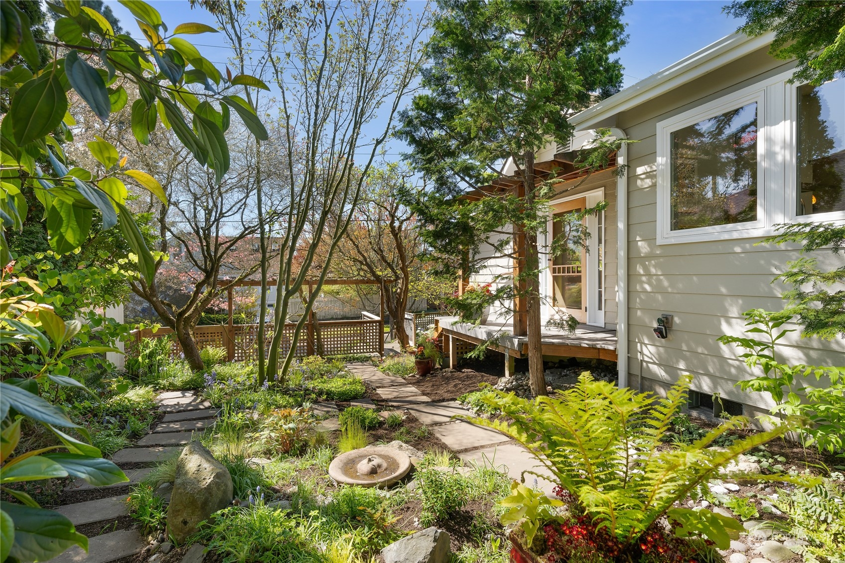 1408 Northwest 73rd Street Seattle, WA 98117 - Photo 33 of 40 a backyard of a house with table and chairs and wooden fence