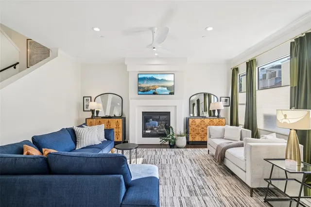 a living room with furniture a fireplace and a flat screen tv