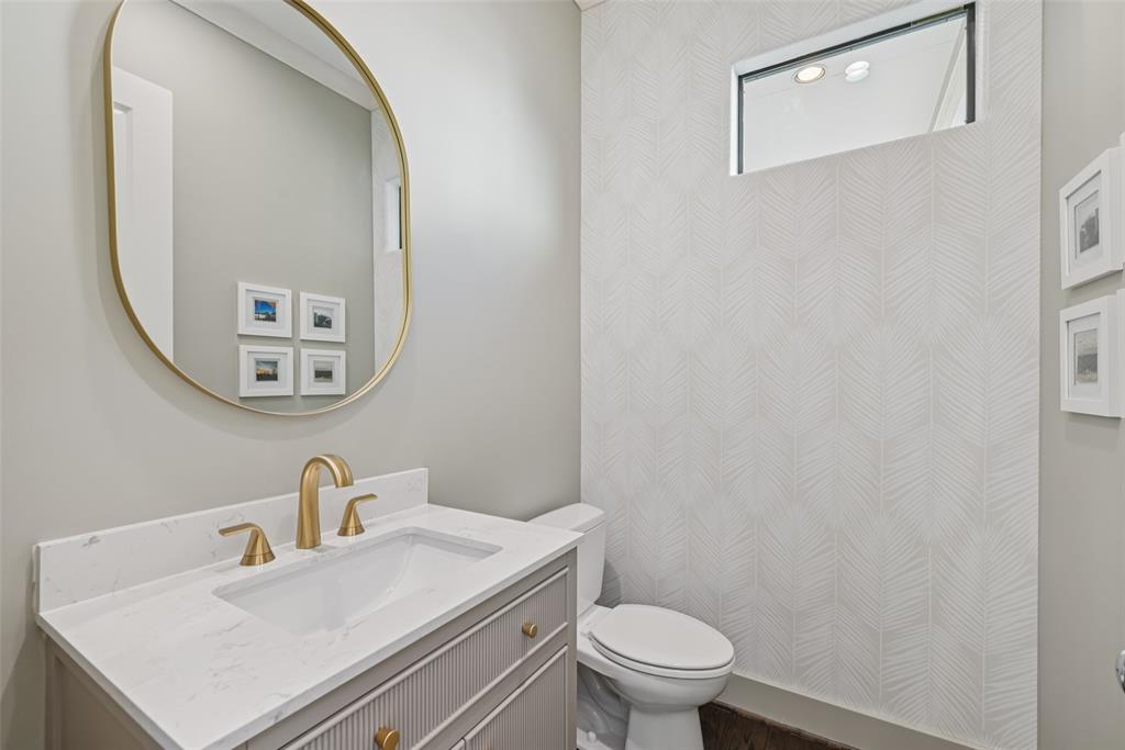 3926 Holland Avenue, Unit 102 Dallas, TX 75219 - Photo 12 of 40 a bathroom with a sink a toilet and a mirror