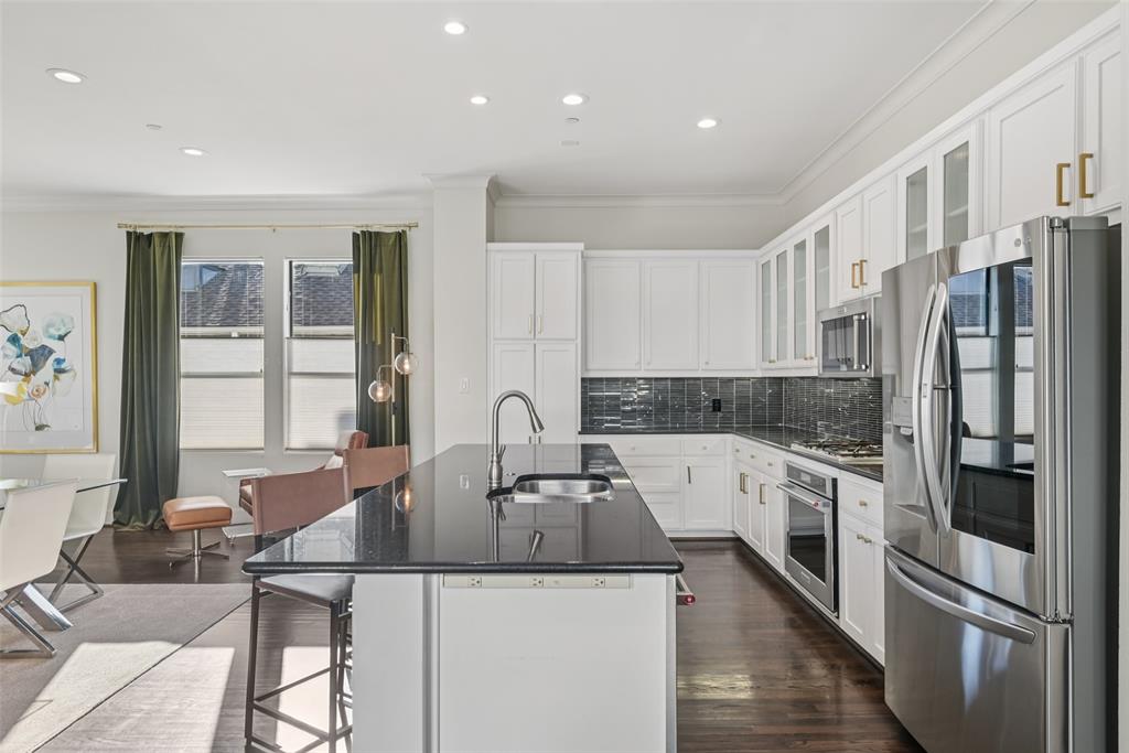 3926 Holland Avenue, Unit 102 Dallas, TX 75219 - Photo 14 of 40 a kitchen with stainless steel appliances granite countertop a refrigerator and a sink