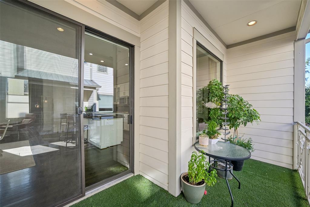 3926 Holland Avenue, Unit 102 Dallas, TX 75219 - Photo 17 of 40 a view of a porch with table and chairs potted plants