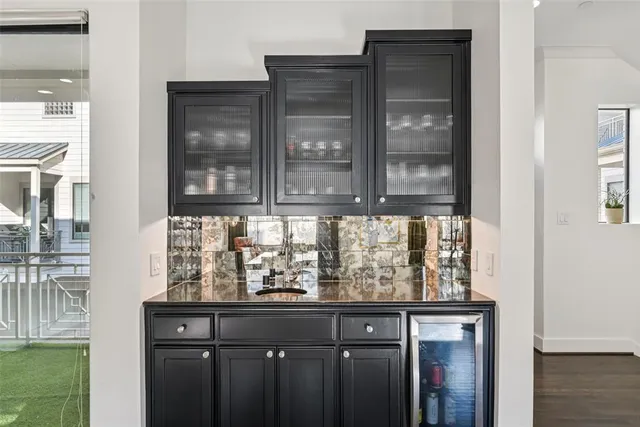 a living room with fireplace furniture and a large window
